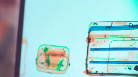 Items scanned in the x-ray machine at an airport security checkpoint station. Video stock 82843937