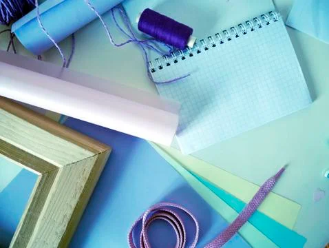 Items for sewing and decorating a gift, colored paper pastel tones for handwork Stock Photos