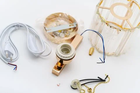 Items on a table for assembling a light fixture in a home setting Stock Photos