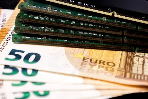 Items on a table include computer memory and fifty euro banknotes arranged in a Stock Photos
