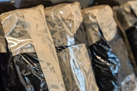 Items wrapped in plastic packaging, highlighting sustainable packaging practices Stock Photos