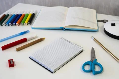 Items for writing and drawing are arranged on a desk with school supplies Stock Photos