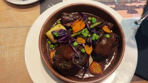 Itional Spanish oxtail stew with potatoes, slow cooked meat in red wine sauce in Stock Footage 303505945