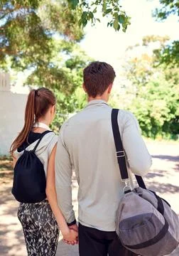 Its all about commitment. a sporty young couple walking together before a Stock Photos