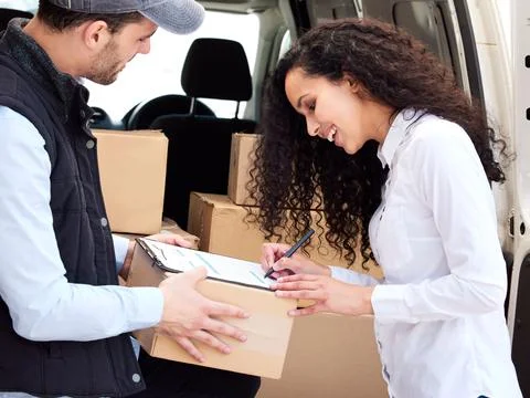 Its always exciting when your parcel arrives. Shot of a customer signing for  Foto stock