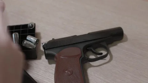 Its ammunition gun bullets on the table, distorting the bolt Stock Footage 55856902