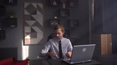 It's been a bad day. Angry businessman hits laptop screen with baseball bat Stock Footage 190548402