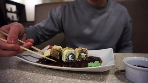 Its difficult to use chopsticks, that's why he choose fork, slow motion Stock Footage 86317834