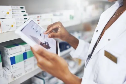 Its easy, efficient and powerful. a pharmacist using a digital tablet in a Stock Photos