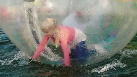 It's fun to run on all fours inside a transparent ball that floats in the pool Stock Footage 80074867