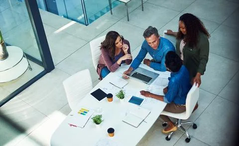 Its fundamental to keep the team on the same page. a group of designers Stock Photos