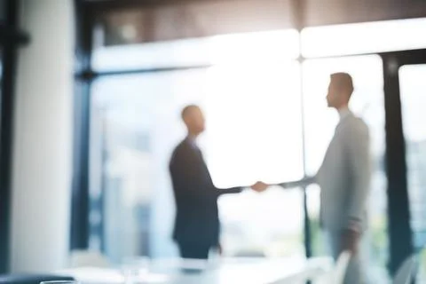 Its going to be one profitable connection. Defocused shot of two businessmen Stock Photos