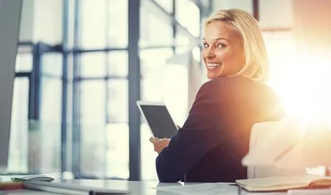 Its got ideal functionality for business. a businesswoman using a digital tablet Stock Photos