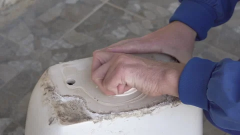 It's hard to unscrew outdated cistern drain valve Stockbeeldmateriaal 328140612