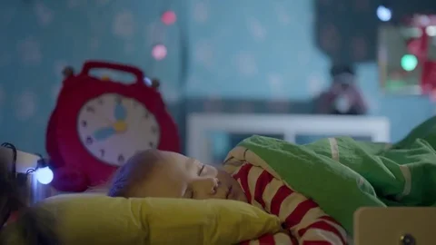 It's midnight on Christmas and Santa Claus is bringing gifts for little boy Stock Footage 73928362