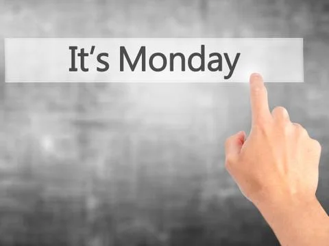 It's Monday - Hand pressing a button on blurred background concept . Business Stock Photos