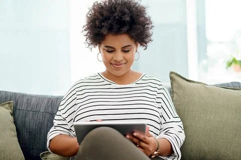 Its much more convenient to work wirelessly. Shot of a young businesswoman using Stock Photos