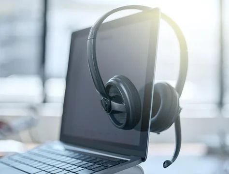 Its a new day to solve problems. a set of headsets resting on a laptop in an Foto stock