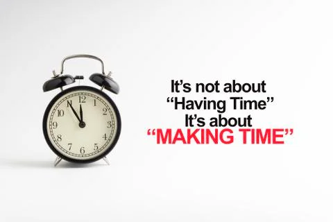 IT'S NOT ABOUT HAVING TIME IT'S ABOUT MAKING TIME inscription written and alarm 库存照片