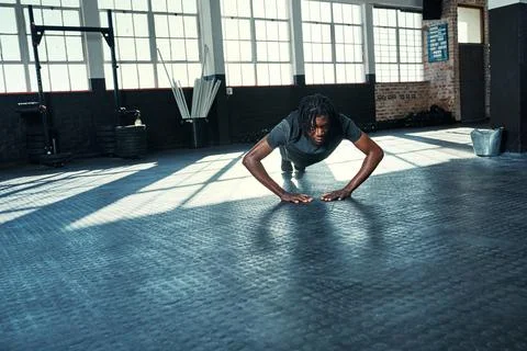 Its not about having time, its about making time. a young man doing push ups in Stock Photos