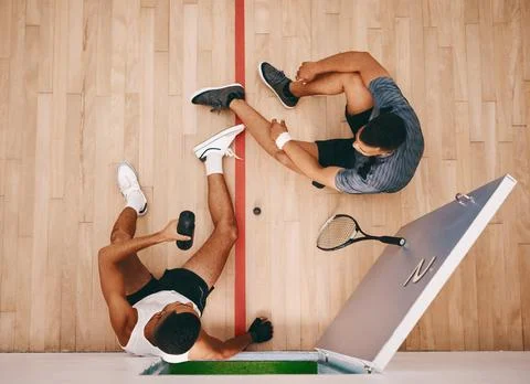 Its not a game of squash without your buddy. two young men chatting during a Stock Photos