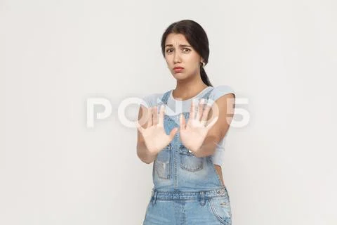 It's not that. Shocked young adult woman posing on gray background. Stock Photos