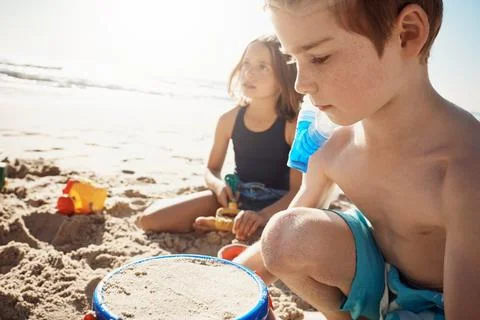 Its not summer until youve built your first sandcastle. an adorable little boy Stock Photos