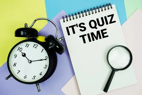 It's Quiz Time text written on notepad with alarm clock on pastel background Stock Photos