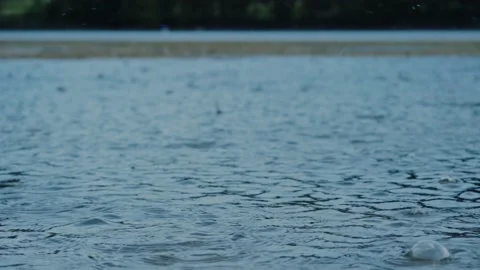 It's raining on lake. rain dropping on water, water circles from rain drops.  Stock Footage 205840883