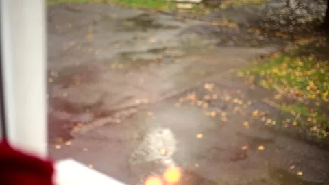 It's raining outside the window, a candle is burning on the windowsill, there's Stock Footage 142790808