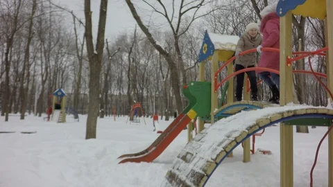 It's snowing, it's cold. Little children have fun in the winter. Video stock 87740665