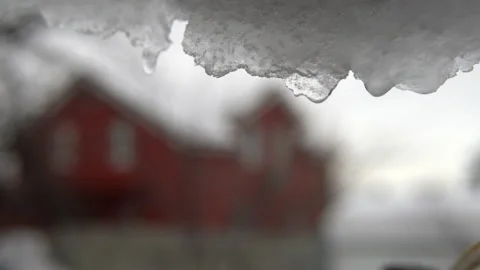 It's spring outside and the snow is melting against the background of a red Stock Footage 149829768
