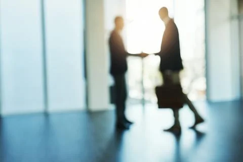 Its the start of doing great things together. Defocused shot of two businessmen Stock Photos