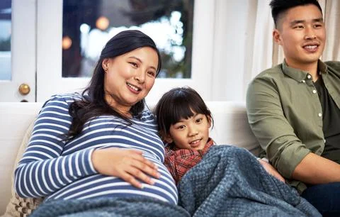 Its their family tradition to watch a movie every weekend together. a family Stock Photos
