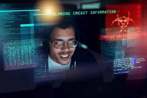 Its time to attack. Shot of a young hacker cracking a computer code in the da Stock-Fotos