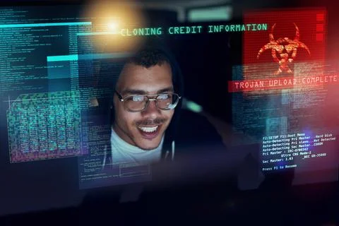 Its time to attack. Shot of a young hacker cracking a computer code in the dark. Foto stock