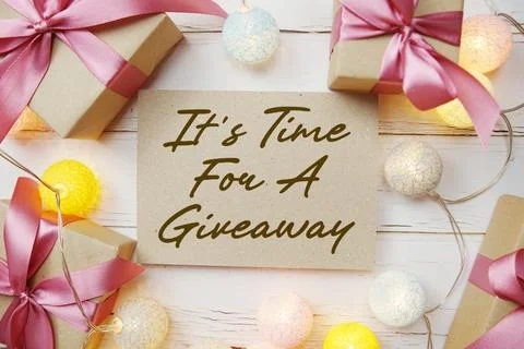 It's Time For A Giveaway text with gift present and LED cotton balls decora.. Stock Photos
