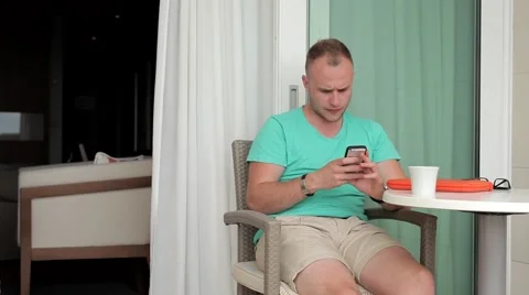 It’s too hot here. Man resting on luxury hotel balcony. Video stock 53809003