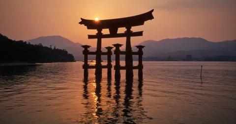 Itsukushima Torii Gate Sun Disk Above Crossbeam High Tide Sunset Medium Video stock 344694044