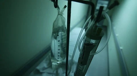IV bag attached to gurney with sheets in hospital hallway HD Video Stock Footage