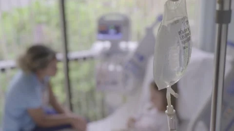 An IV bag hanging in a hospital room stock photo - OFFSET