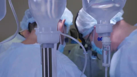 Iv drip and surgeons performing operation in the background Video stock 162816345