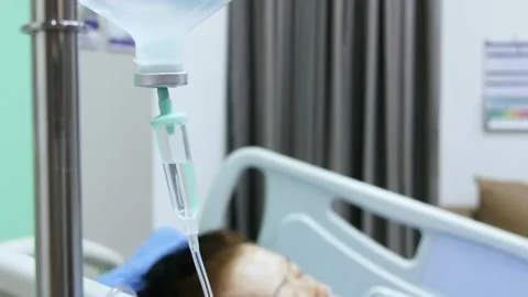 Iv drip dropping continuously rate, close up shot.  with patient on bed. Stock Footage 154614565