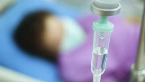 Iv drip dropping continuously rate ,close up shot and patient with face mask. Stock Footage 154614575