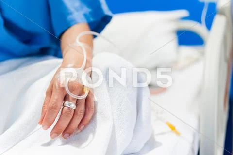 Iv drip in woman hand Stock Photos