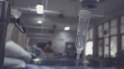 IV infusion. Liquid saline is slowly dripping drops of drugs, medicine or Stock Footage 113689521