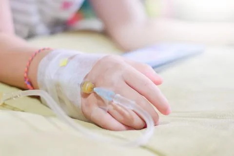IV solution in a child's patients hand,Close up Children patient's hand Stock Photos