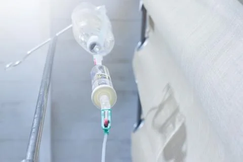 Iv solution infusion, bottom view of saline bottle from the eyes of the patient Stock Photos