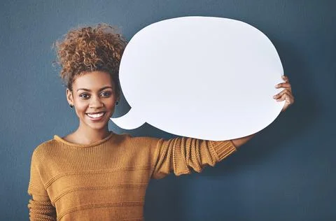 Ive got something to say. Studio shot of a young woman holding a speech bubble Stock Photos