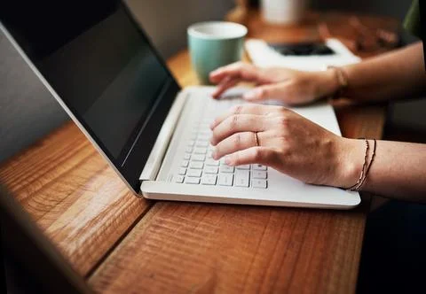 Ive had to learn how to type fast. an unrecognizable businesswoman sitting alone Stock Photos